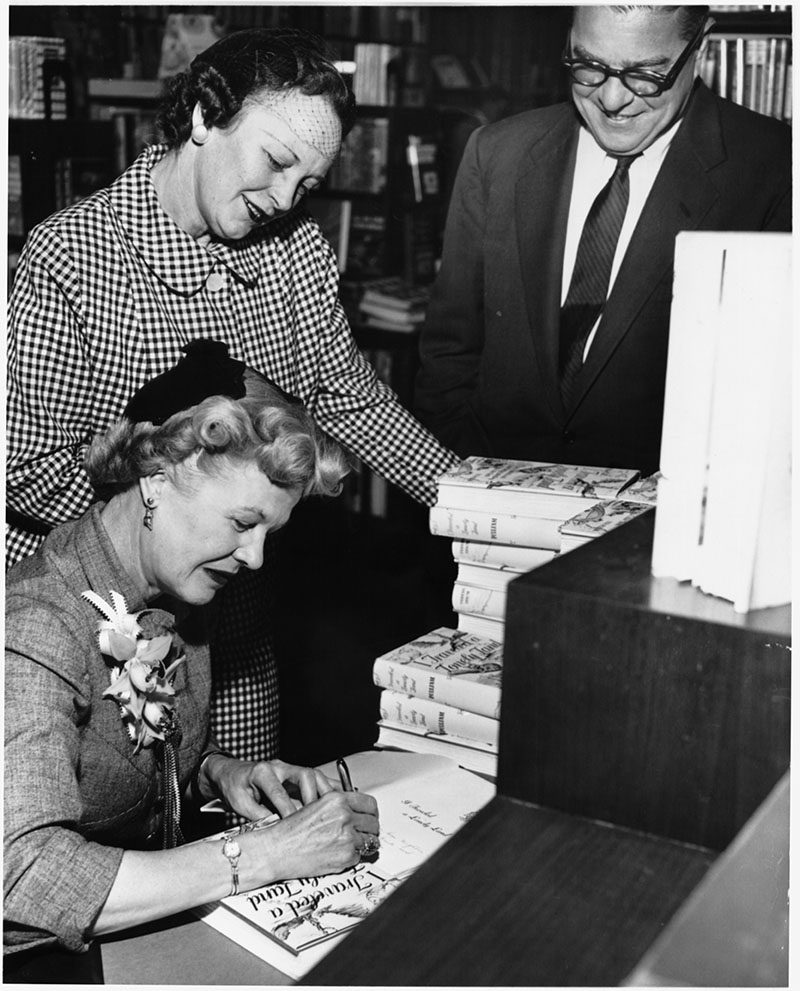 Mrs. Pulliam signs copies of her book in 1955,"I Traveled a Lonely Land.